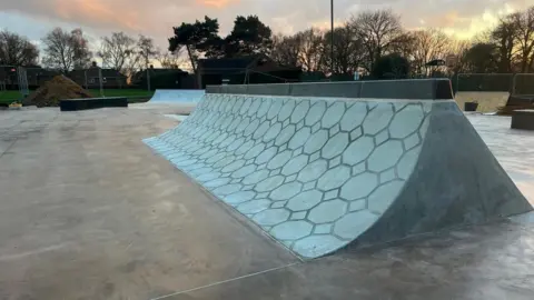 Owen Sennitt/BBC A skate ramp is in the foreground with other obstacles behind