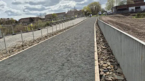 A whin dust path leading towards a park
