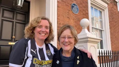 Kate Walker who is wearing a Notts Couty football shirt next to Dr Sue Ward who is wearing glasses