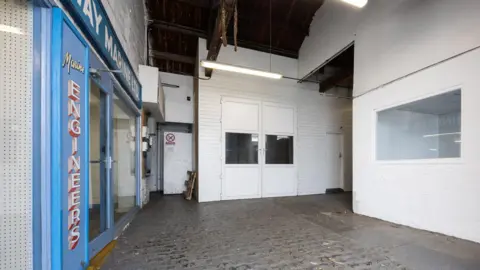 Guernsey Ports The outside entrance of the former slaughterhouse in Guernsey. It is painted white but completely empty inside. 