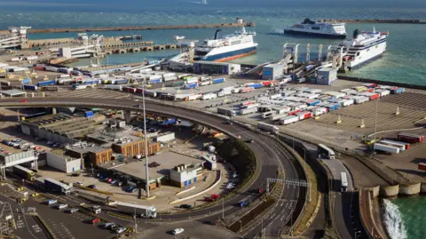 Heavy goods vehicles waiting to board ferry at port of Dover in UK 