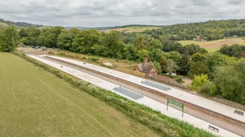 SDNPA Sam Moore An overhead view of the restoration work on Centurion Way, which passes through where the former Singleton station is. Green fields can be seen either side of Centurion Way, and a green sign for Singleton station has been preserved.