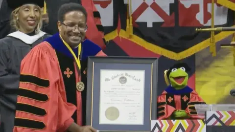 Kermit the Frog receives award after finishing his speech at the University of Maryland.