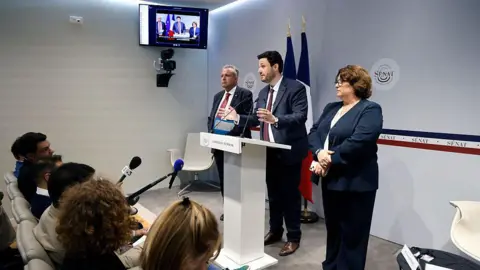 Getty Images French Senator Alexandre Ouizille (C), flanked by French Senators Laurent Burgoa (L) and Antoinette Guhl (R), presents the Senate commission of enquiry report about French industrial mineral waters during a press conference at the French Senate, Upper house of the French Parliament, in Paris on May 19, 2025