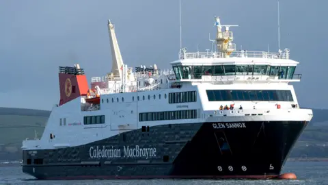 A large black and white ferry with red funnels. It has Caledonian MacBrayne and Glen Sannox written on the side in white 