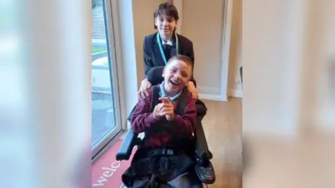 family photo Izzy Lally with brother Ryan in wheelchair