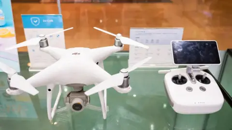 Getty Images Chinese-made drones, an array that includes these models shown in Guangzhou, in a store