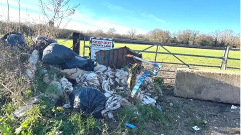 Colin Rayner Rubbish outside farm land