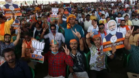 Getty Images A crowd - mainly without masks - at a BJP rally