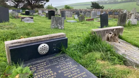 A graveyard with the stones lying down.