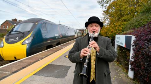 Philip Lowe playing his clarinet at Penrith Station