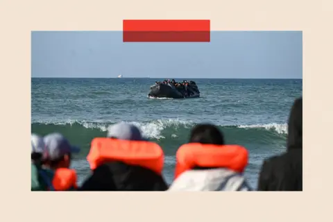 Getty Images/ Bernard Barron People wait to board an already loaded boat in order to attempt crossing the English channel 