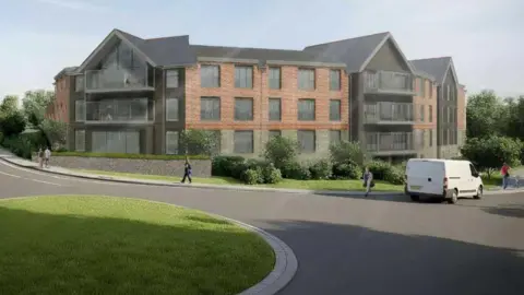 Saunders Boston Architects An artist's impression of the planned care home which is made of red brick and has balconies on black gabled sections. It sits next to a grassy roundabout which a white van is turning off. There are pedestrians on the pavements. 