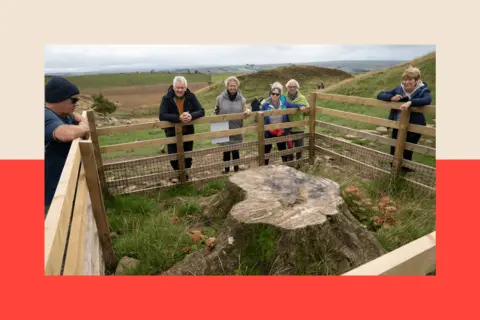 PA Media People gather around the stump of the Sycamore Gap tree in Northumberland National Park