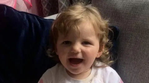 Family handout Maya, a young girl smiles at the camera