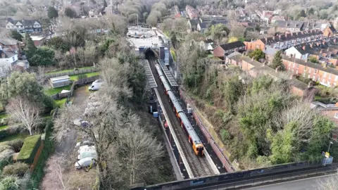 An overhead view of Moseley Village station. A train can be seen on the platform.