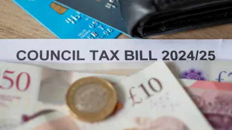 Getty Images Stock image of a council tax bill, covered up with banknotes and a credit card