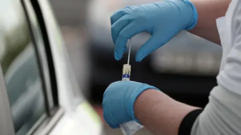 Reuters A swab test at a car window