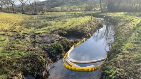 BBC Nant Pibwr with a yellow plastic boom across it