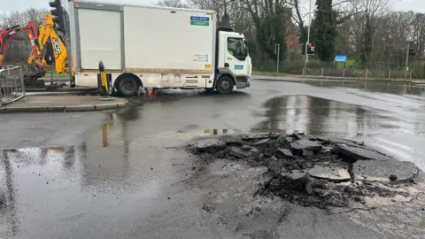 A sinkhole at Victoria Road East in Leicester with a Severn Trent Water lorry nearby.