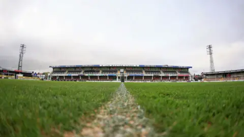 General view of Edgar Street stadium from the middle of the pitch. Seats and advertisement boards can be seen in the background.
