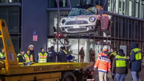 A Mini Cooper used in the Munich attack is removed from the scene