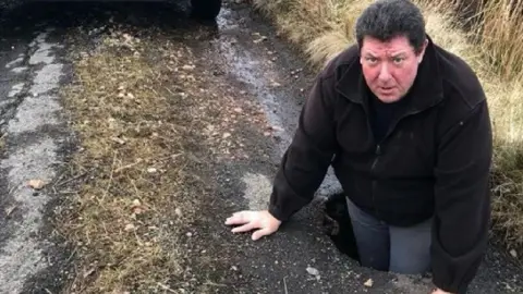 Stuart Ross in a pothole