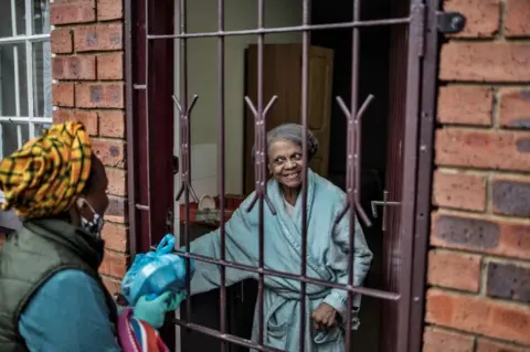 AFP Hope for Vrededorp grassroots organisation delivers a food parcel residents of a care home on 27 April.