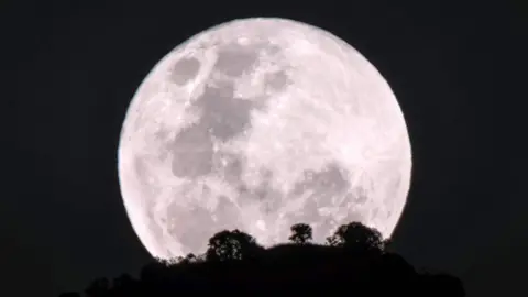 AFP The moon rises over Kadam mountain in Nakapiripirit town, northeastern Uganda, on January 31, 2018, during the lunar phenomenon referred to as the "super blue blood moon"
