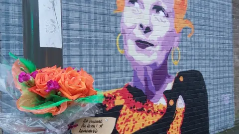 Deggy Flowers left by the mural to Vivienne Westwood