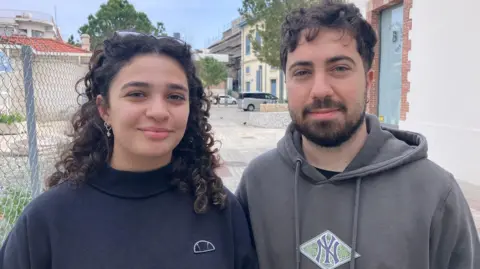 A couple in Limassol - a woman in a blue top and a man in a grey sweatshirt
