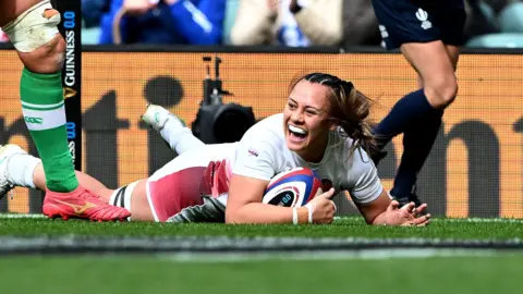 Maddie Feaunati scores a try for England