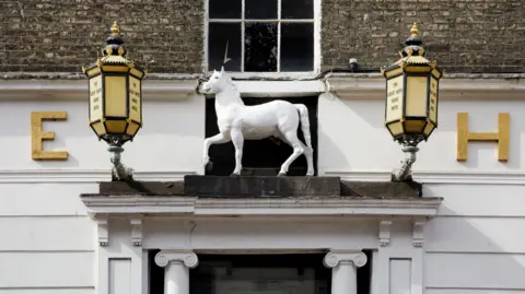 PA Media The outside of the hotel. It is a close-up picture showing a statue of a white horse.