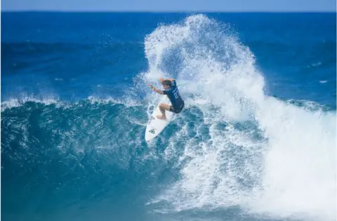 Getty Images Matthew McGillivray of South Africa surfing around bright blue seas and waves.