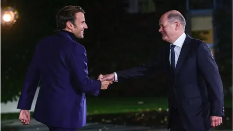 Getty Images French President Emmanuel Macron shaking hands with German Chancellor Olaf Scholz - file photo