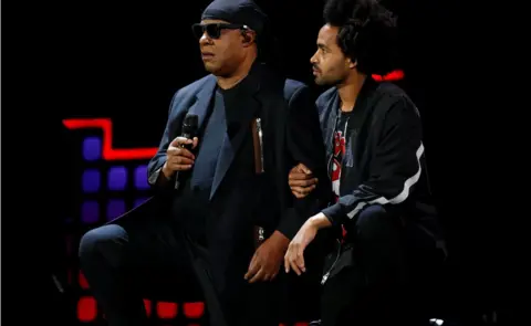 Reuters Singer Stevie Wonder takes a knee before performing at the 2017 Global Citizens Festival at Central Park in New York, U.S., September 23, 2017