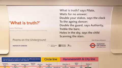 A close up of a advertising card in a Tube carriage with poem printed on it called What is Truth? by Louis Macneice.