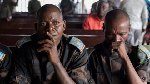 Members of the Congolese army, sentenced to death for desertion and cowardice when fighting M23 rebels, sit inside the military courtroom during their trial, North Kivu province, Democratic Republic of Congo