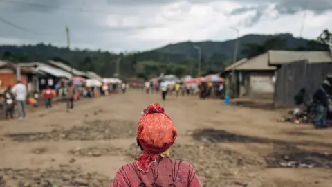 Getty Images A woman crosses the Mweso market, Masisi Territory, eastern Democratic Republic of the Congo