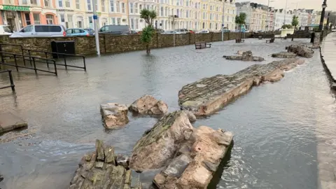 Wall knocked down by waves