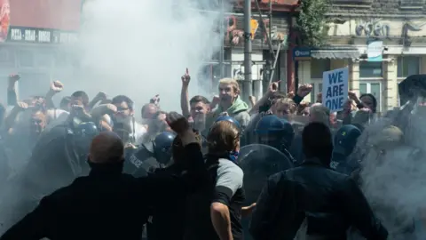 BBC / Red Seam / Little Door  A protest turns into a riot on the streets of Port Talbot in The Way