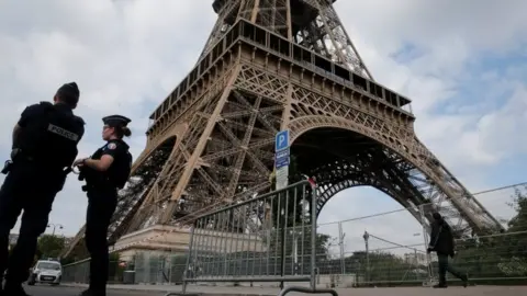 Reuters French police patrol near the Eiffel tower as part of security measures in Paris, France, 13 July 2017.