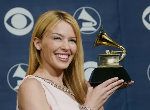 Getty Images Winner of best Dance Recording Musical Artist Kylie Minogue poses backstage in the Pressroom at the 46th Annual Grammy Awards held on 8 February 2004 at the Staples Center, in Los Angeles, California.