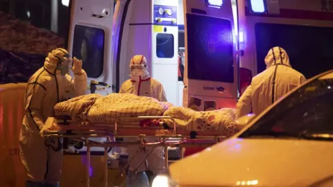 EPA Medical staff transfers a patient at Hospital of Wuhan Red Cross Society in Wuhan City, Hubei Province, China