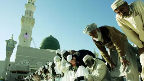 Getty Images Pilgrims pray in the courtyard of the Prophet Mohammed Mosque in the holy Saudi city of Medina