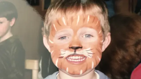 Family photo Conner Marshall as a child with his face painted like a tiger