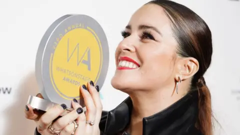 PA Media Actress Lucie Jones poses with her trophy at the WhatsOnStage Awards