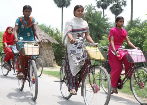 Getty Images Girls cycle home from high school on bicycles provided by the Bihar state government