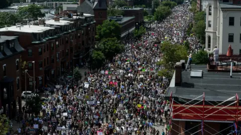 Reuters People march towards the Boston Commons to protest the Boston Free Speech Rally in Boston, 19 August 2017
