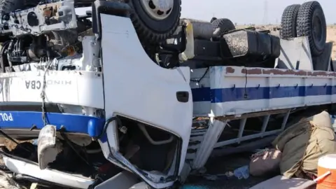 Handout A police truck overturned in Dhadar, Pakistan